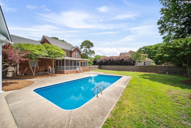 view of swimming pool featuring a patio, a fenced backyard, a sunroom, a fenced in pool, and a yard