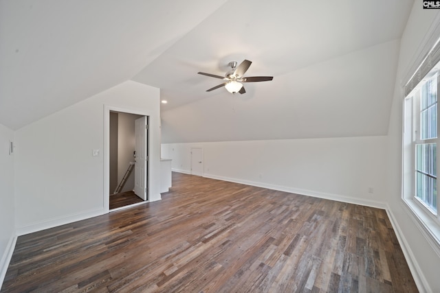 bonus room with baseboards, ceiling fan, dark wood finished floors, and lofted ceiling