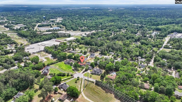 birds eye view of property with a view of trees