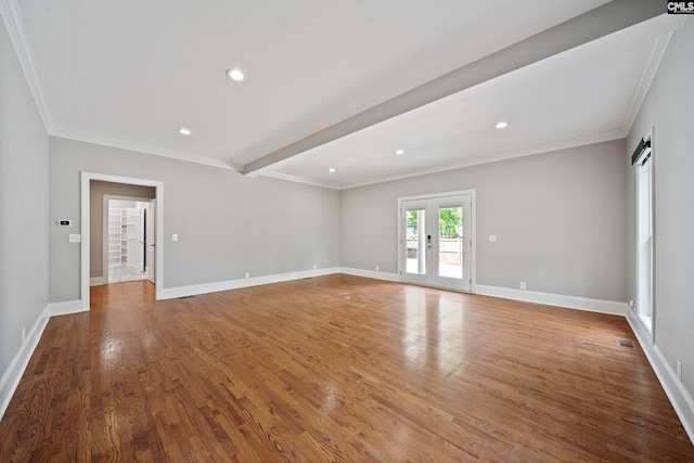 unfurnished living room featuring baseboards, ornamental molding, wood finished floors, and recessed lighting