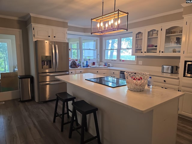 kitchen with a kitchen island, dark wood finished floors, stainless steel fridge with ice dispenser, black electric stovetop, and white cabinetry