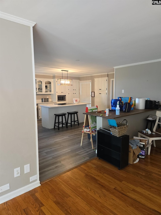 living room featuring crown molding, baseboards, a notable chandelier, and dark wood-style floors