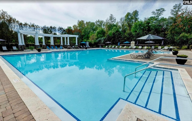 pool featuring a pergola and a patio area