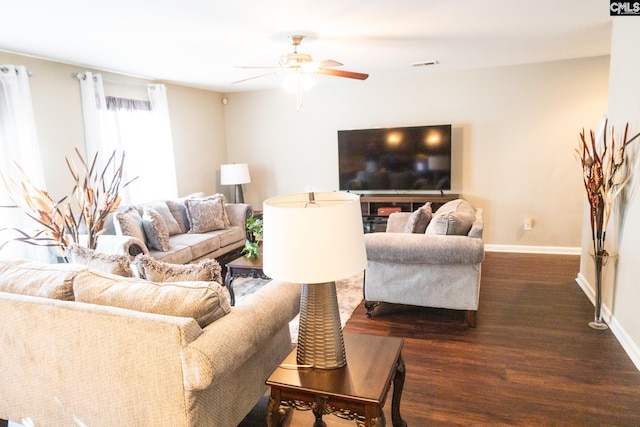 living room with baseboards, ceiling fan, dark wood-style floors, and visible vents