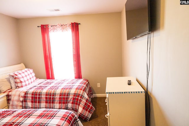 carpeted bedroom featuring baseboards and visible vents
