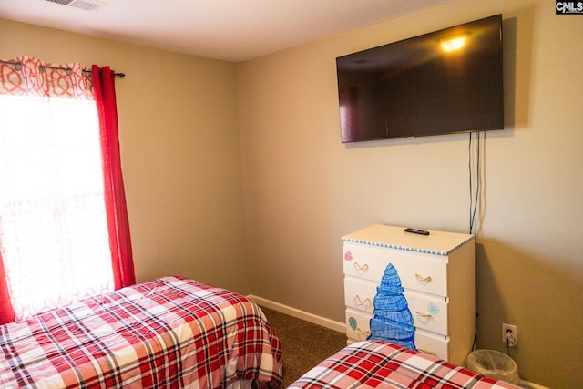 bedroom featuring carpet floors and baseboards