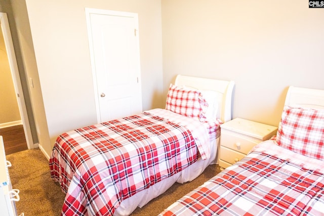 bedroom with baseboards and carpet