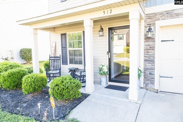 property entrance with a porch and stone siding