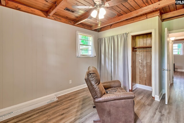 living area with a healthy amount of sunlight, wood ceiling, a ceiling fan, and wood finished floors