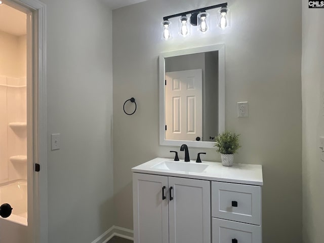 full bath featuring baseboards and vanity