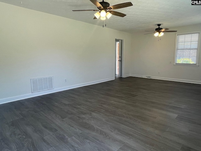 empty room with a ceiling fan, baseboards, visible vents, and dark wood-style floors