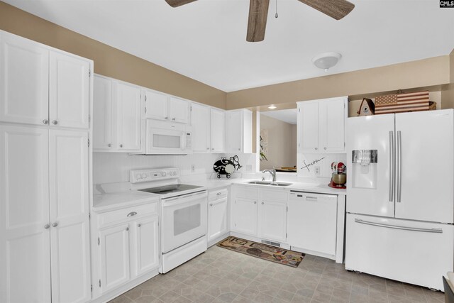 kitchen featuring white appliances, ceiling fan, light countertops, white cabinets, and a sink