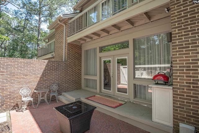 view of patio with a balcony and french doors