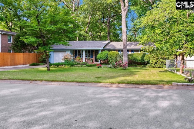ranch-style home with a garage, a front lawn, aphalt driveway, and fence