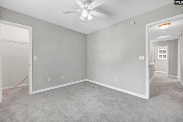 unfurnished bedroom with carpet floors, baseboards, and a spacious closet