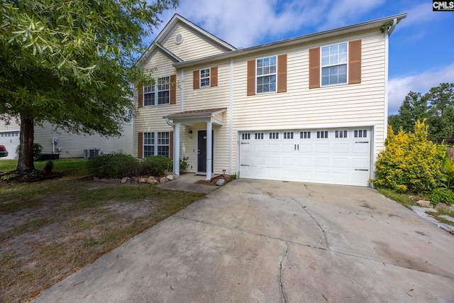 view of front facade featuring a garage, central AC unit, and concrete driveway