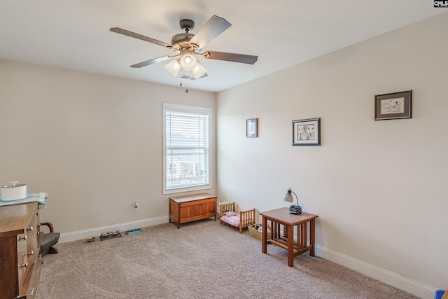 miscellaneous room featuring baseboards, ceiling fan, and carpet