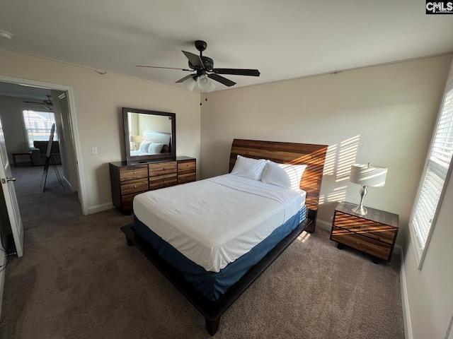 carpeted bedroom with baseboards and a ceiling fan