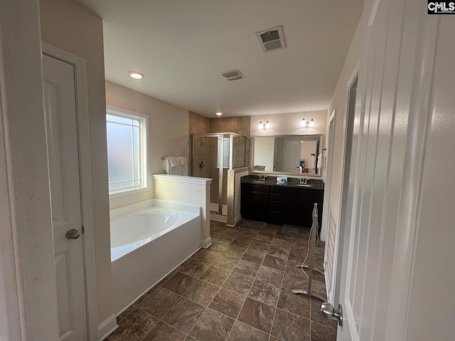 bathroom featuring visible vents, vanity, a garden tub, and a shower stall