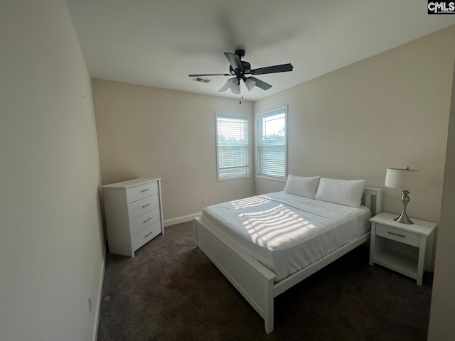 bedroom featuring a ceiling fan, baseboards, visible vents, and dark colored carpet