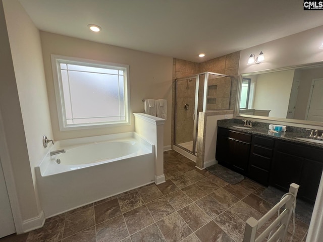 full bath featuring double vanity, a sink, a bath, and a shower stall
