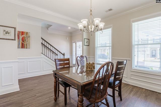 dining space featuring dark wood-style flooring, a chandelier, visible vents, and a healthy amount of sunlight