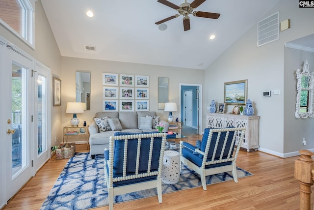 living room with visible vents, ceiling fan, high vaulted ceiling, and light wood-type flooring