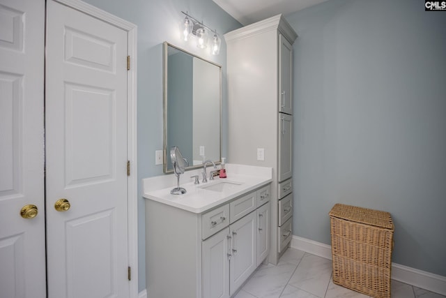 bathroom featuring vanity, baseboards, and marble finish floor