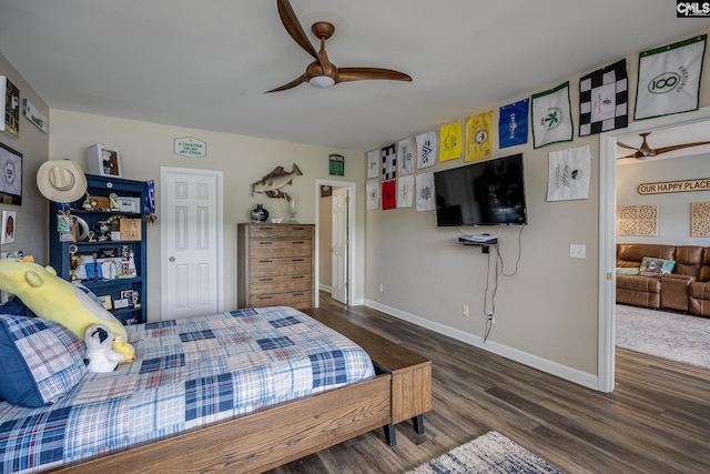 bedroom featuring baseboards, ceiling fan, and wood finished floors