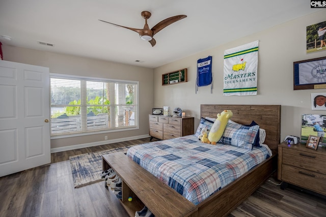 bedroom featuring baseboards, a ceiling fan, wood finished floors, and visible vents