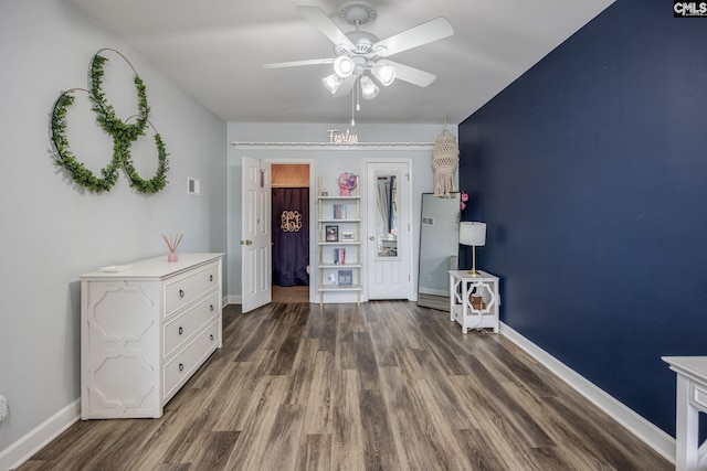 unfurnished bedroom featuring baseboards, ceiling fan, and wood finished floors