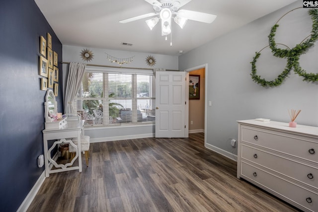interior space featuring visible vents, baseboards, ceiling fan with notable chandelier, and dark wood-style floors