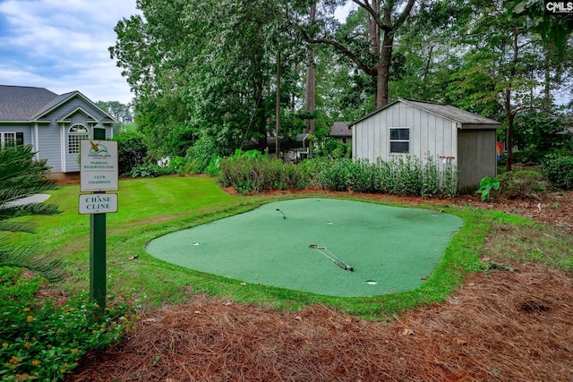 surrounding community with an outdoor structure and a yard