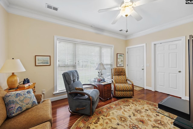 living area with a wealth of natural light, ornamental molding, wood finished floors, and visible vents