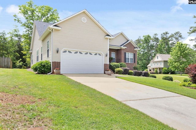 view of front of house with an attached garage, driveway, a front lawn, and brick siding