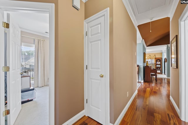 hall featuring crown molding, baseboards, attic access, and hardwood / wood-style floors