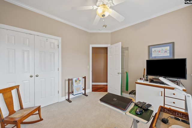 carpeted office with crown molding, a ceiling fan, and baseboards