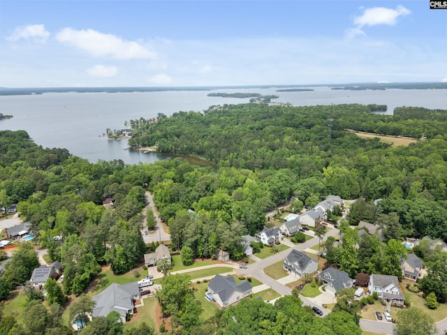 drone / aerial view with a residential view, a water view, and a wooded view