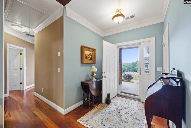 foyer featuring crown molding, baseboards, visible vents, and wood finished floors