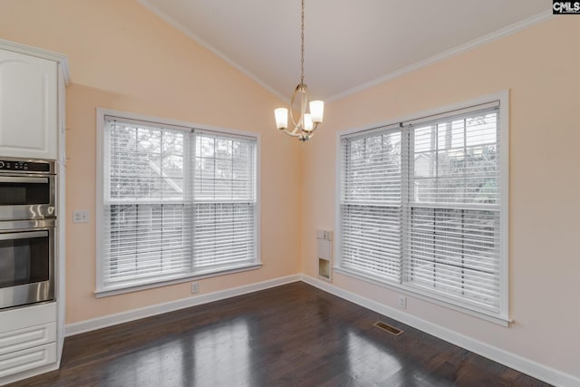 unfurnished dining area featuring crown molding, dark wood-type flooring, lofted ceiling, and a notable chandelier