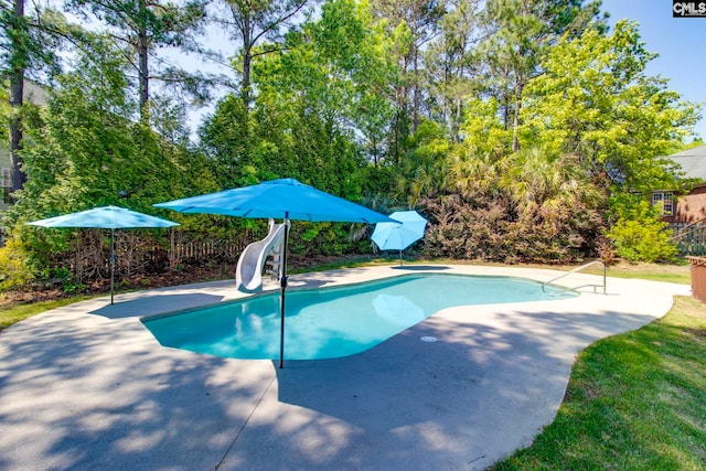 view of pool featuring a patio and a water slide