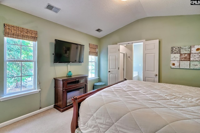 bedroom with carpet floors, visible vents, multiple windows, and lofted ceiling
