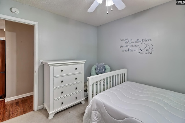 carpeted bedroom featuring baseboards and ceiling fan