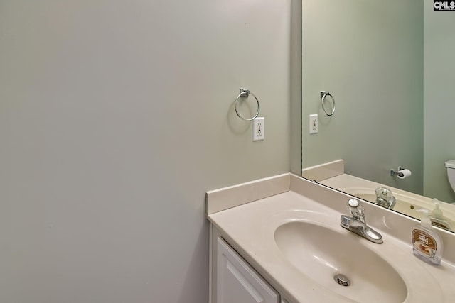 bathroom featuring vanity and toilet