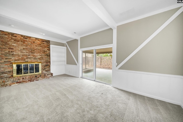 unfurnished living room with beam ceiling, carpet, and a fireplace