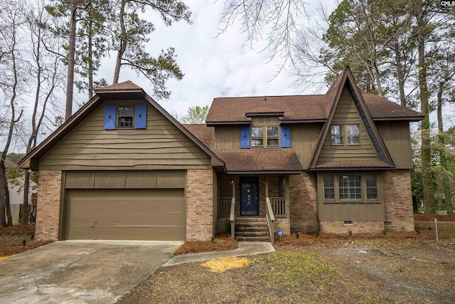 view of front of house with covered porch, concrete driveway, brick siding, and crawl space