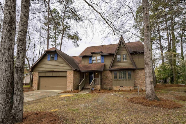 craftsman house with crawl space, driveway, brick siding, an attached garage, and a shingled roof