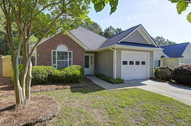single story home featuring roof with shingles, fence, an attached garage, a front lawn, and concrete driveway