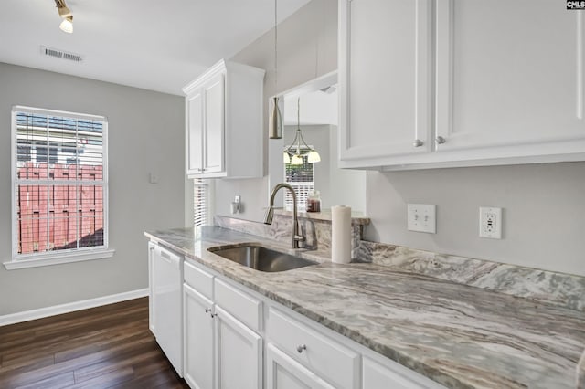 kitchen featuring visible vents, dark wood-style flooring, baseboards, a sink, and a wealth of natural light
