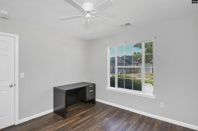 unfurnished room with baseboards, dark wood-type flooring, visible vents, and ceiling fan